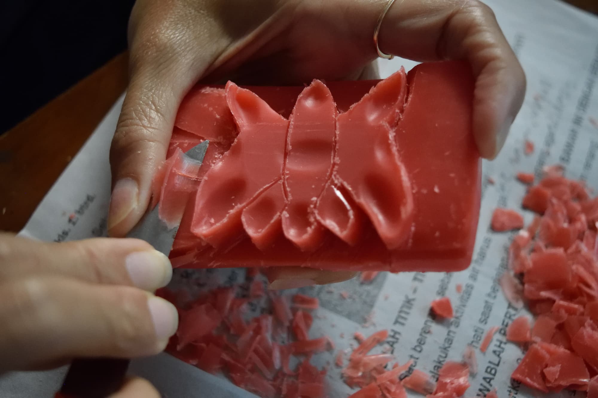 a elderly man whittles away at a soap bar